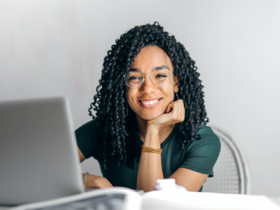 young-woman-working-on-laptop-smiling.png